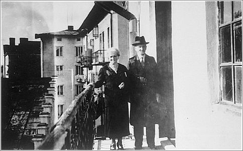 An elderly Jewish couple poses on the balcony of their home in Przemysl